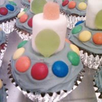 Alien Ufo Cupcakes I made these for my sons birthday at school. I used the silver cupcake liners and tinted my icing gray to add to the "ufo" effect...