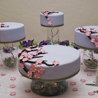 Cherry Blossom Satellite Cake This bride wanted a non-traditional display concept and this is what we did. The vases have glass marbles and battery operated tealights....
