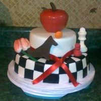 Twilight Saga Twilight cake for my daughter's 22nd birthday. Chocolate apple, chess pieces, tulip, wolf and moon. yellow cake with chocolate filling...