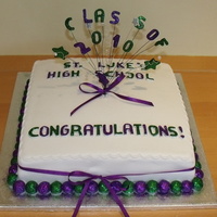 High School Graduation Sponge covered in fondant, with edible (and very sparkly!) glitter in green and purple to match the school uniform colours.