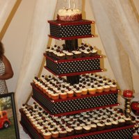 50's Wedding Cupcakes This is a 4 tier cupcake stand i built with300 chocolate cupcakes filled with strawberry cheesecake and cherry cheesecake. on the top is a...
