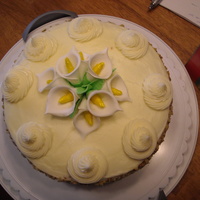 Carrot Cake With Lilies Actually made this for a birthday, but seems more like easter. Carrot cake with creamcheese frosting, chopped nuts around the edge, with...