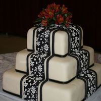 Black & White Fondant Cake stacked white fondant cake with black fondant drapes, royal icing accents.