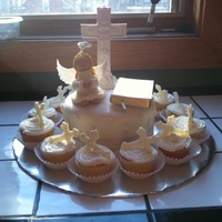 My Goddaughter's First Communion She wanted Vanilla cup cakes with vanilla frosting and cross candies. I did that and a chocolate cake with home made marshmallow fondant....