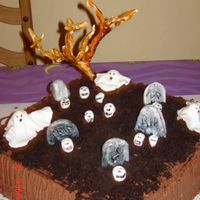 Graveyard.jpg Grave Yard Cake....triple chocolate cake w chocolate buttercream icing.....The ghost, skulls, tumbstones,tree and dirt all edible.....I...