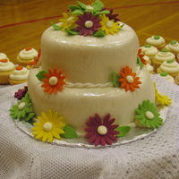 Daisies Strawberry-filled lemon cake with lemon buttercream and fondant. The daisies almost perfectly match the colors in the brides bouquet and...