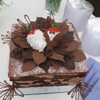 Chocolate Decadence groom wanted a chocolate cake that you could eat with your eyes. Recipe has 3.5 lbs chocolate 2.5 lbs butter and 2 dozen eggs.