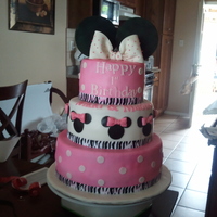 Minnie Mouse Cake With Zebra This cake was chocolate with cream cheese covered in fondant, decorations are fondant/gumpaste. This was my second attempt at this cake.