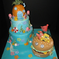 Spongebob Birthday Cake Vanilla cake covered in ganache and MMF. All decorations are MMF except Spongebob and Patrick... they are make of modeling chocolate. The...