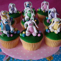 Happy Easter Cupcakes with green icing and bunny's and eggs made from fondant.