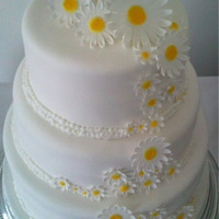 Daisies Cake 3 tier lemon cake with lemon curd buttercream. Each tier decorated with white fondant and finished with royal icing pearls and handmade...