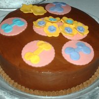 Dog Bones And Flowers Triple chocolate cake with caramel frosting inbetween the layers and accents around the base. The rest is covered in fudge frosting and...