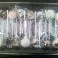 Cake Pops Red velvet and cream cheese frosting cake pops with pink, white, and dark chocolate coating.