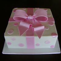 Baby Shower Present Dark Chocolate cake, fudge filling and buttercream icing. Gumpaste bow and fondant enverything else!