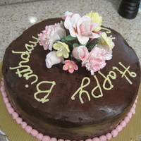 Ganache Cake With Flower Bouquet The cake is frosted with chocolate ganache. These were my first gumpaste flowers. The bouquet is inserted into the cake with a cake pick.