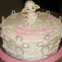 Baby Dedication Yellow cake covered in vanilla buttercream. Lamb made of white chocolate - flowers from buttercream and fondant.