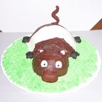 Pig Brown and White pig made for a two year olds birthday party. His own personal cake. All buttercreme with fondant accents.