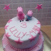 Peppa Pig Cake With Stars 2 tier peppa pig cake with star decorations.