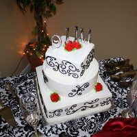 Square/round/square With Free Form Scrolls Very happy with this cake. The bride and entire wedding party absolutely loved it.
