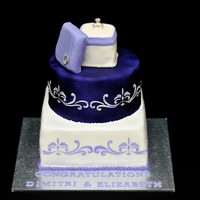 Engagement Cake This 2 tier cake has an edible ring box placed on top...the ring is not edible. Stenciled done with Royal icing and the box is made of RKT...