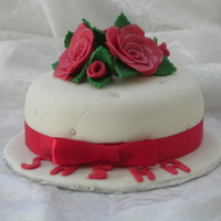 Sasha's Birthday Cake Cake covered in fondant with modeling chocolate roses