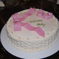 Pink Baby Shower Cake 12" round baby shower cake. Iced in buttercream with basketweave sides. Shoes and bow were gumpaste. Thanks for looking