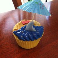 Jaws Cupcake I had fun with this, the sand is crushed graham cracker and butter cream frosting. The shark fin is fondant and I just bought a paper...