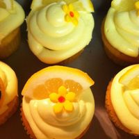 Lemon Cupcakes This was a lemon cake filled with lemon pudding, topped with lemon icing. I sliced up a lemon into wedges and made fondant flowers.