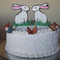 Easter Cake With Chocolate Bunnies And Butterflies An experimental Easter cake. New red velvet recipe and crusting butter cream. The BC did not crust properly so I could not get it very...