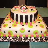 Yellow Cake With Buttercream Frosting Covered In Fondant And Decorated With Gumpaste The bottom is a 12x12 square yellow cake. The top is a 9" round yellow cake. I covered it in buttercream fondant and used gumpaste to...