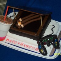 A Few Of His Favorite Things.... This a cake I made for my husband's birthday. The base cake is yellow cake w. cream cheese frosting and covered in white fondant, the...