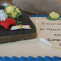 Dr. Marcie Graduation Cake 2011 This cake is a chocolate cake with Raspberry filling. Rice Crispy treats book covered with fondant. the declaration is fondant written on...