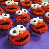 Elmo Cupcakes Elmo Cupcakes: chocolate cupcakes with crescent shape cut out for mouth then red icing piped on with star tip. Necco wafers used for eyes...