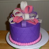 Purple Cake With Multi-Loop Fondant Bow Buttercream with fondant bow and quilted diamond pattern.