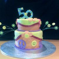 60S Themed 50Th Bday Cake First attempt at 2 tier sponger cake. Fondant icing with fondant decs, gumpaste 50 and wire mounted decs.
