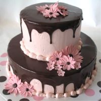 Pink Daisies And Ganache Flowers done in fondant/gum paste mix, pink IMBC topped with dark chocolate ganache.