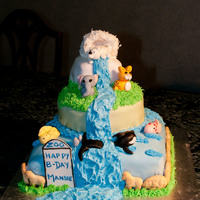 Birthday Zoo Cake Three layer yellow cake filled with custard and chocolate buttercream, covered in fondant. Waterfall icing and igloo is rice crispy, icing...