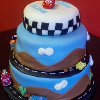 Cars Birthday Cake Fondant Cake with fondant and buttercream decorations and toy cars.