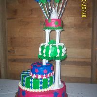 100_1463.jpg The bride did not want a traditional wedding cake. She saw this cake in a Wilton Wedding cake book. and we made some changes. It is frosted...