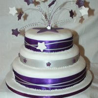 Purple Starburst A Handfasting cake with 3 tiers decorated in fondant, ribbons and gumpaste stars