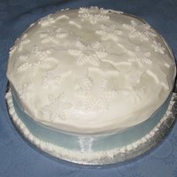 Snowy Christmas Royal Icing covered cake with dusted fondant snowflakes