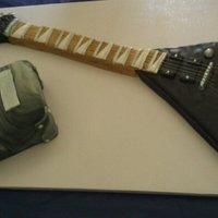 Gibson Flying V Guitar this was my 8th cake ever. two things seems against me in thie cake which were the heat (95 and humid) and trying a new fondant (which i...
