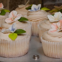 Wedding Cupcake Almond cupcake with maple frosting. Gumpaste hydrangea dusted with colors of the wedding theme.
