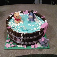 Pooh Baby Shower Cake cake surrounded by kit-kats decorated with icing. pooh figures where actual bath toys