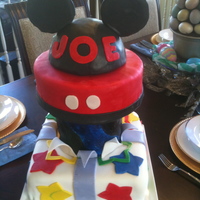 Mickey Mouse Birthday Cake! We really loved making this cake. Lemon with Lemon ButterCream. All fondant decor. 10 inch square bottom, 6 inch rounds exploding out of...