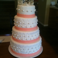 Royal Wedding Cake 4 tier. Bottom Tier is Strawberry with Strawberries and Vanilla Cream filling. Top three tiers are lemon cake with lemon buttercream...