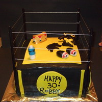 Boxing Ring Cake 12" Boxing ring cake. Yellow cake filled with chocolate ganache and custard. All decorations are made out of MMF