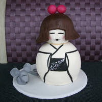 Kokeshi Doll Sculpted Cake Japanese Kokeshi Doll inspired sculpted cake with asian mouse sidekick. Fondant covered vanilla cake with vanilla buttercream filling....