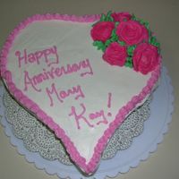 Annivery Cake With Pink Roses Vanilla creme cake with almond flavored buttercream frosting. Roses done in royal icing.