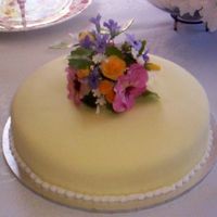 Kitchen Tea Cake Marble cake iced in fondant with a posy of pansies, roses, violets and filler flowers. I inadvertently matched the colour of the bride-to-...